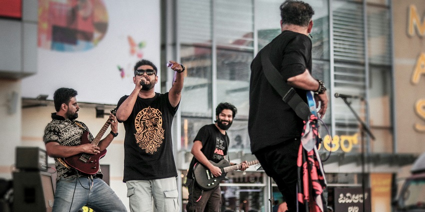 Musicians performing with their instruments on the stage at Rainforest World Music Festival.