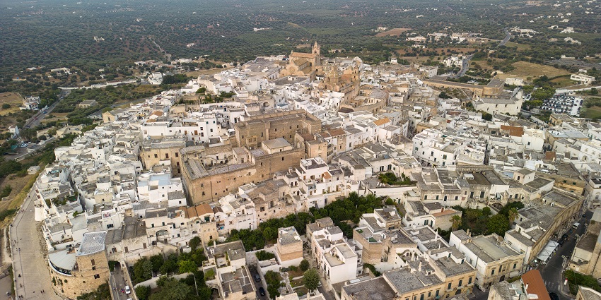 The hilltop town of Ostuni glows in shades of gold and white under the southern Italian sun