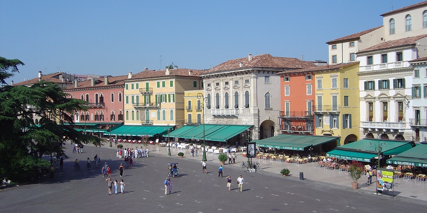 Lively square with cafes and historic buildings near the Arena di Verona.