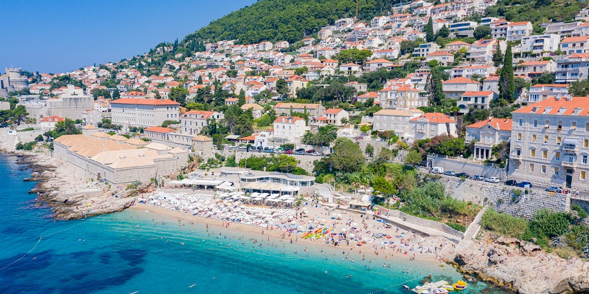 Lay back on Banje Beach’s pebbles, shaded by pines and kissed by breeze and blue.