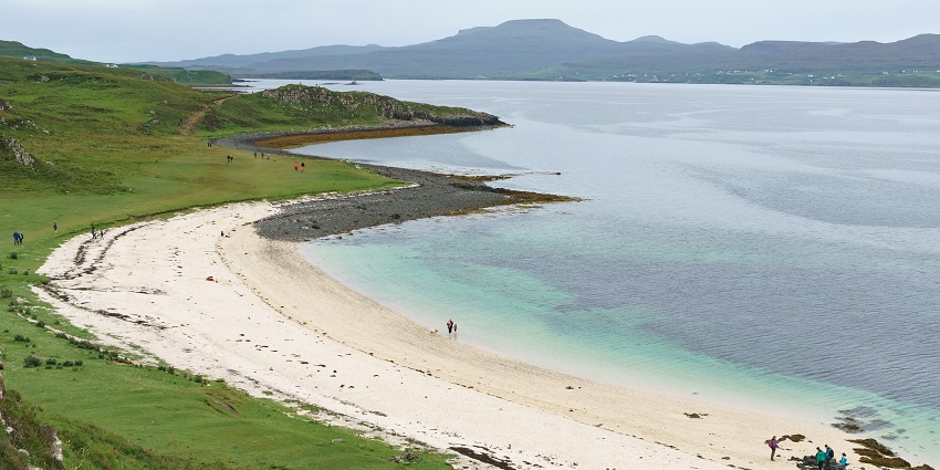 Bright white beach with coral-like sand, giving the illusion of a tropical shore in Scotland.