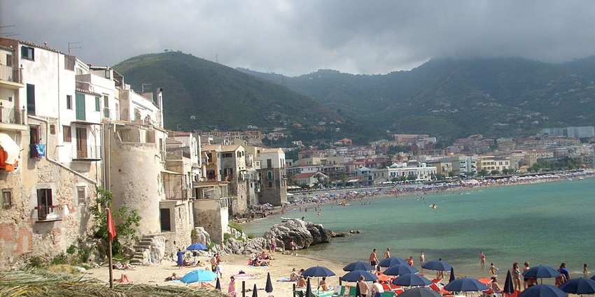 Bask in the sun on Cefalù’s sandy beach, framed by medieval architecture and turquoise Mediterranean waters, among the best things to do in Sicily, Italy.