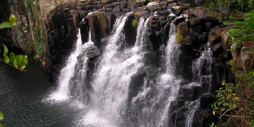 Waterfall cascading over rectangular lava rocks at Rochester Falls in southern Mauritius