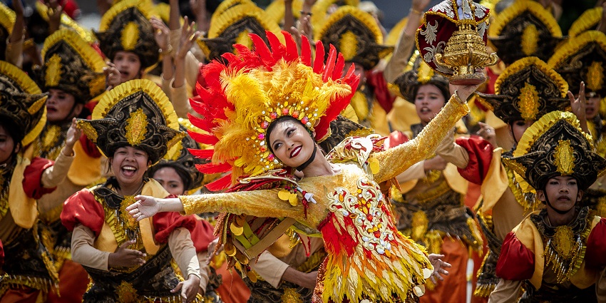 A beautiful performance displayed by an energetic dancer and her troupe on the stage.