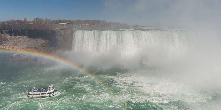 A picturesque rainbow is formed in the mist created by the Horshoe Waterfall in Canada