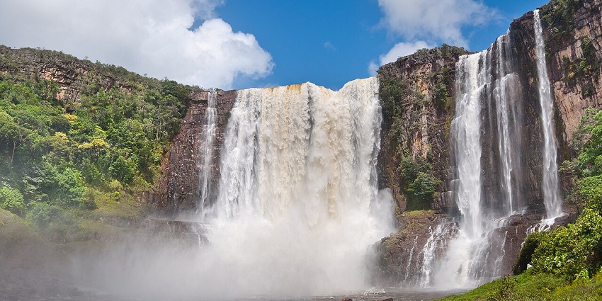 Towering streams of water at Salto Aponwao create a misty area at the bottom of the waterfall