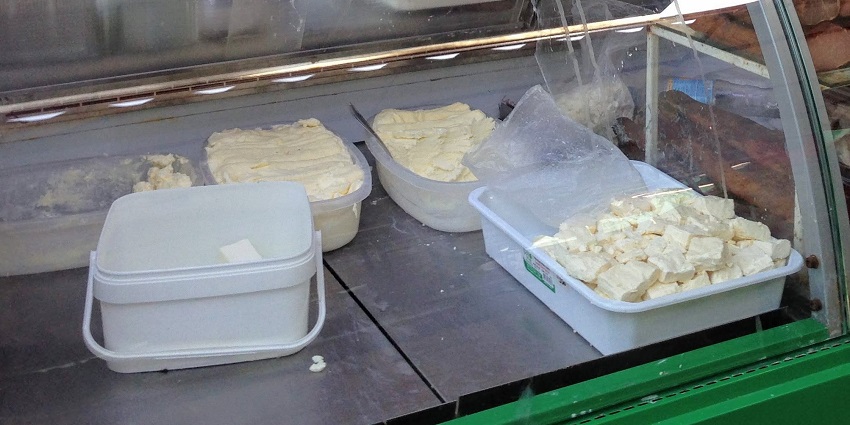 Kajmak cheese is a creamy, spreadable dairy product with a rich, buttery flavor, traditionally made from milk fat in Balkan cuisine.