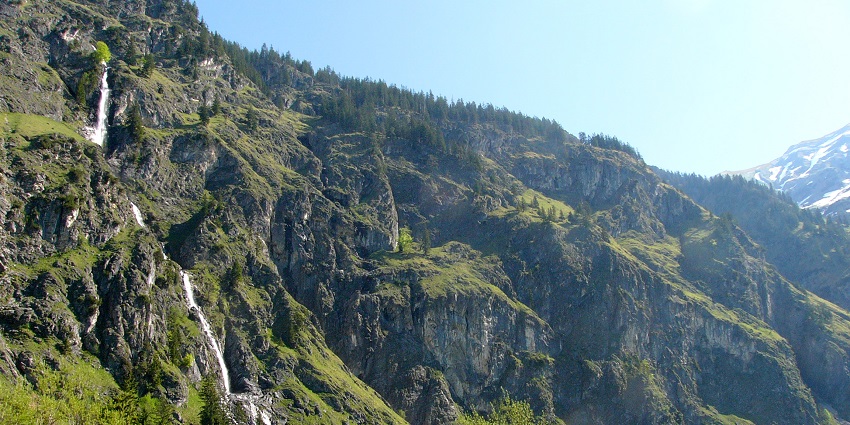 The Seebach Waterfall near Mallnitz, Austria, cascades among rocks and lush woodland.