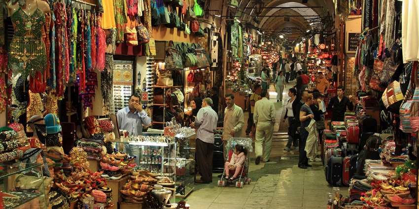 Open markets selling colourful gifts as shoppers tend to the wares and buyers bargain