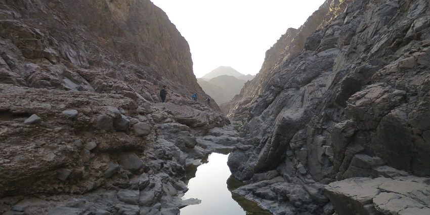 The dry valley of Wadi Shawka is located in the Hajar Mountains with a few travellers roaming freely.