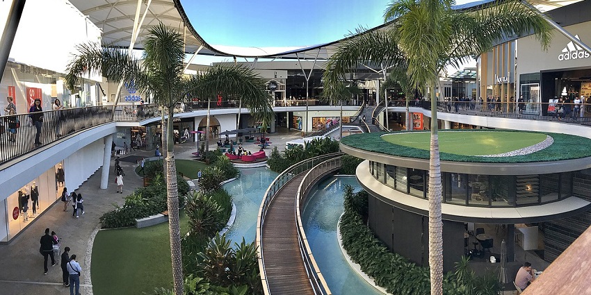 The scenic view of the Shopping Centre open design blends retail with a tropical ambience.