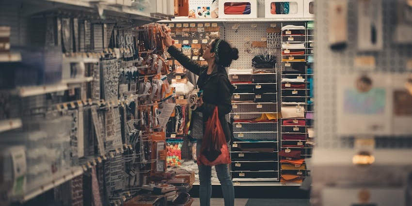 A woman shopping for souvenirs at the Evolution Store, an exciting thing to do in SoHo.