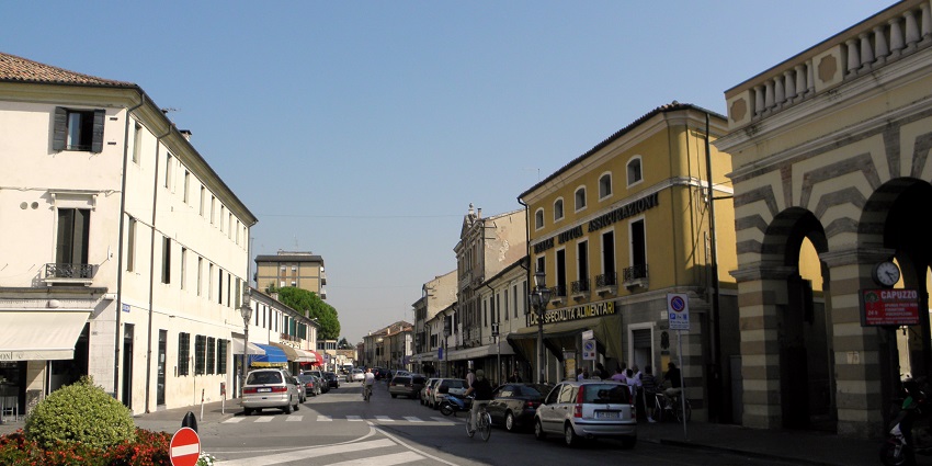 Fashionable shopping street lined with luxury boutiques and Italian designer stores.