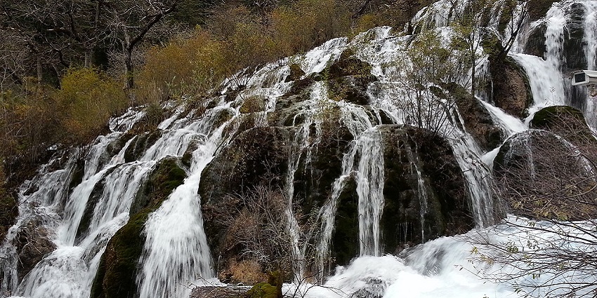 Shuzheng waterfalls in Shuzheng Valley flowing over rocks in lush valleys in China.