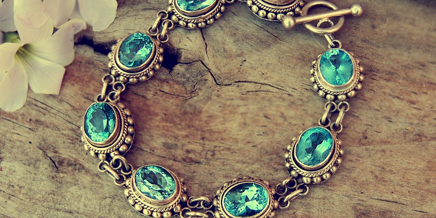 Close-up of silver jewelry, featuring delicate designs with sparkling gemstones, showing its craftsmanship and elegant shine.