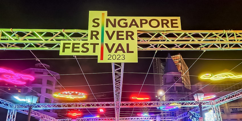 Colourful lights and signage at the beautiful and vibrant Singapore River Festival at night.