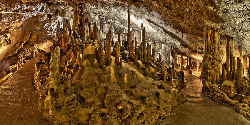 An image of the stunning landscape inside Škocjan, Slovenia Caves, showcasing its limestone formations.
