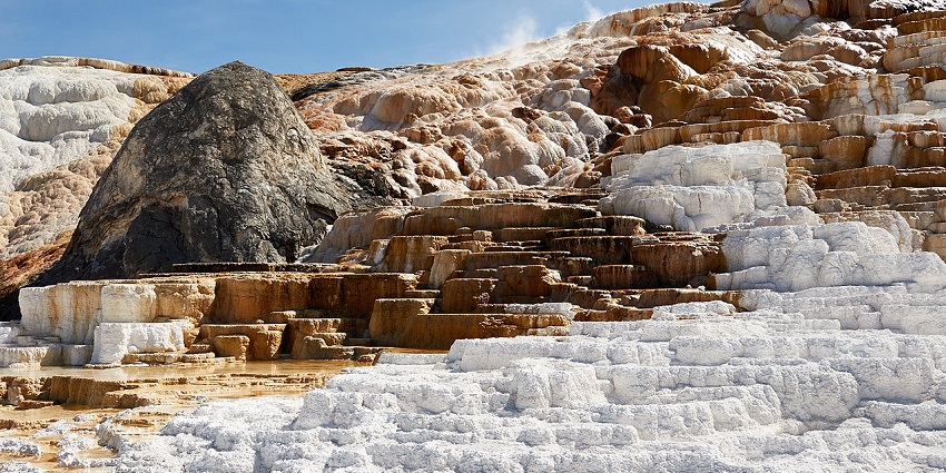 Mesmerising view of the Travertine Hot Springs in Yellowstone under the blue sky