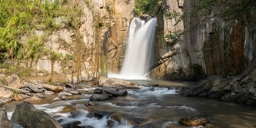 One of the waterfalls in Taiwan, Songlong Rock Waterfall flowing over a rocky riverbed.