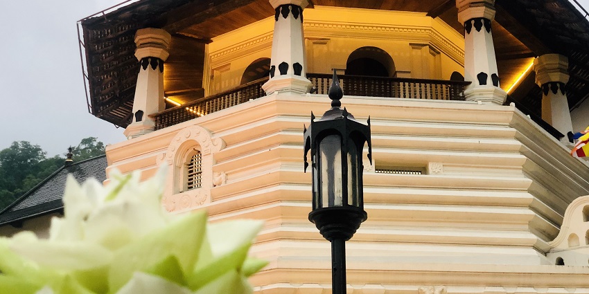 Majestic view of the Sri Dalada Maligawa, surrounded by lush greenery
