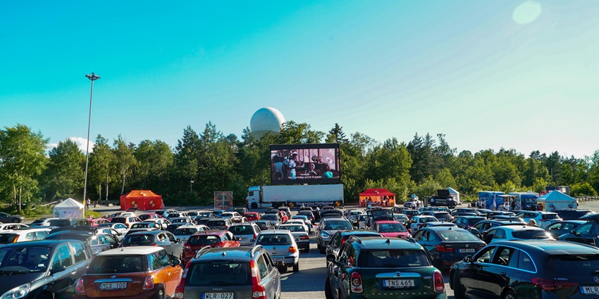 A wide shot of parked cars in front of the screen at Skyline Drive-In Theatre in Barstow.