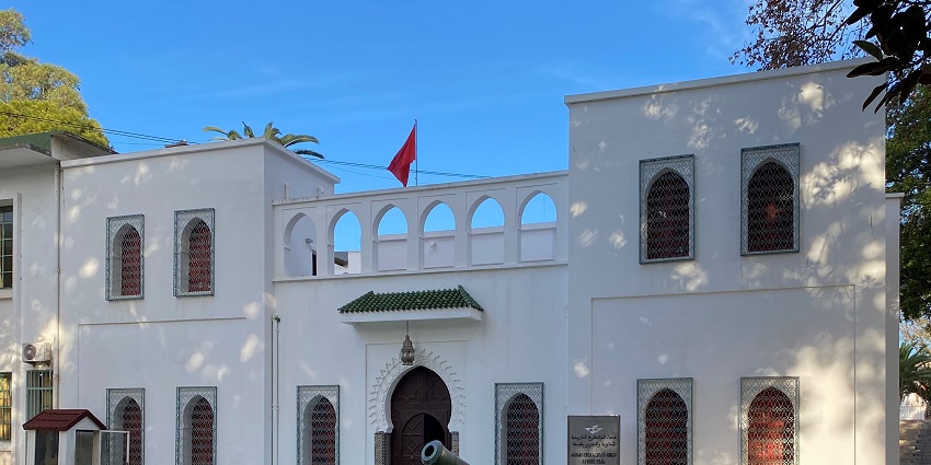 A pristine white building and a rustic canon at the famous Mendoubia Gardens, Morocco.