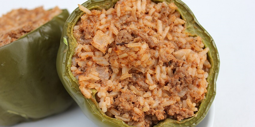 An image showing Hungarian stuffed peppers filled with meat and rice on a serving plate, amongst the best food in Hungary