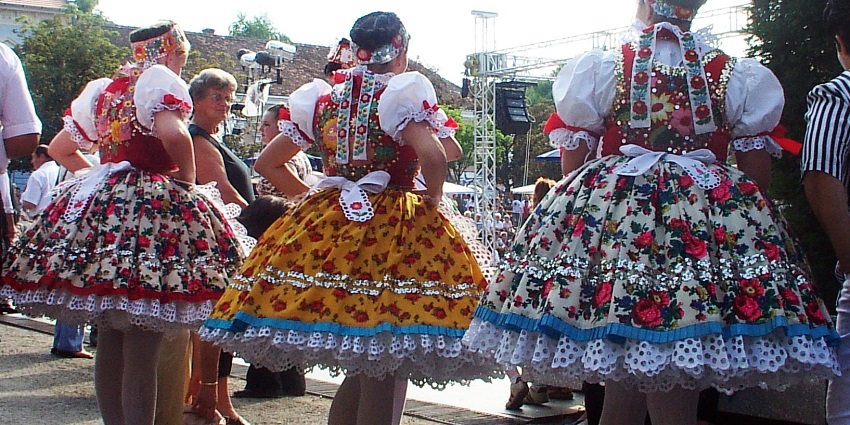 Folk dancers in traditional attire perform at Summerfest in Százhalombatta, celebrating cultural diversity and heritage.