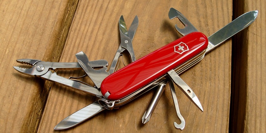 An image showing red Swiss Army Knife with tools open, a famous thing to buy in Switzerland.