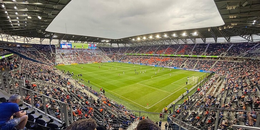 Inside TQL stadium with an ongoing match and people sitting in the stands of the stadium