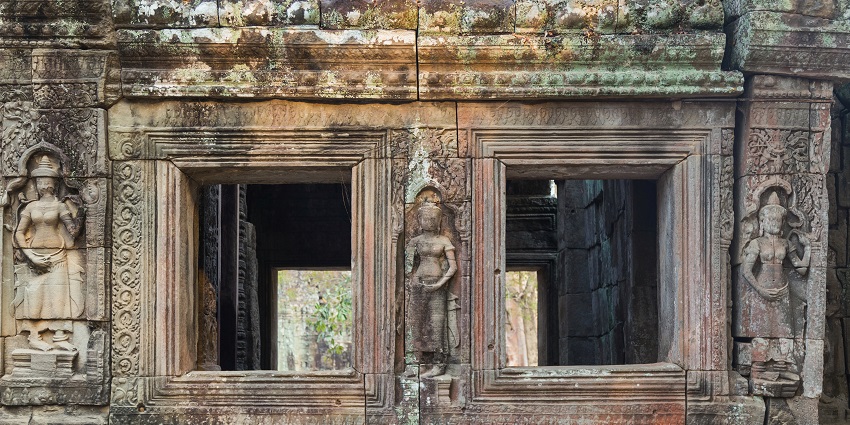 Detailed apsara carvings on temple walls showcasing classic Bayon architecture