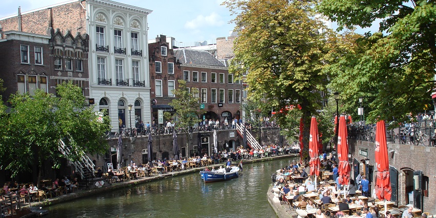 Tourists on a blue boat ride on Utrecht Canal, one of the exciting things to do in Utrecht