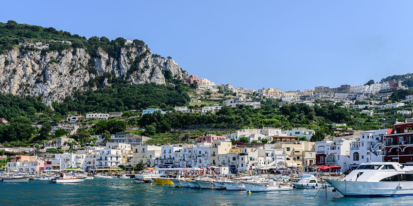 Things to do in Positano include cruising across turquoise waters to explore Capri’s luxury boutiques, Blue Grotto, and scenic cliffs.