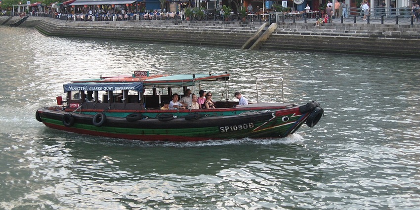 Family on a bumboat tour along Singapore River, one of the best things to do in Singapore with family.