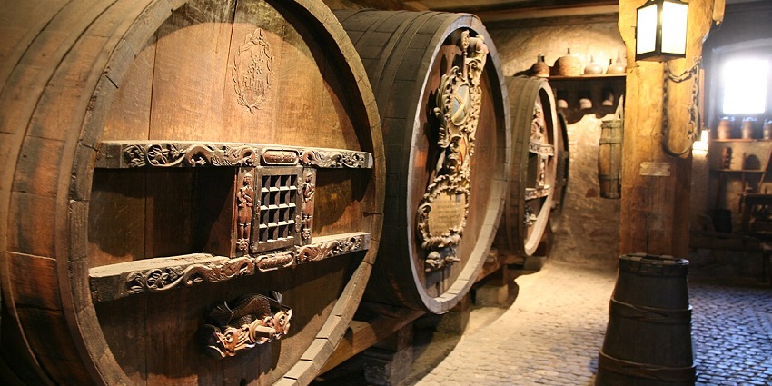 Historical wine barrels on display at Musée d'Unterlinden in Colmar, showcasing history.