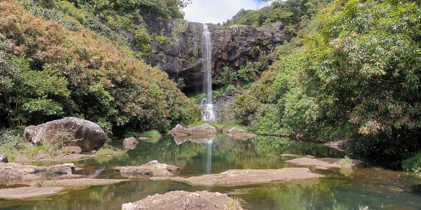 Tamarind Waterfalls upper section with stones in the river and surrounding greenery