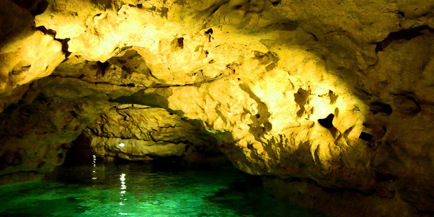 Tapolca Lake Cave, with rowboats gliding on turquoise waters, caves to see in Hungary
