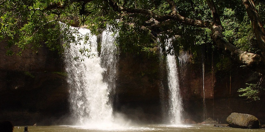 Tat Mok Waterfall flowing through a peaceful forest setting, offering a serene natural escape.