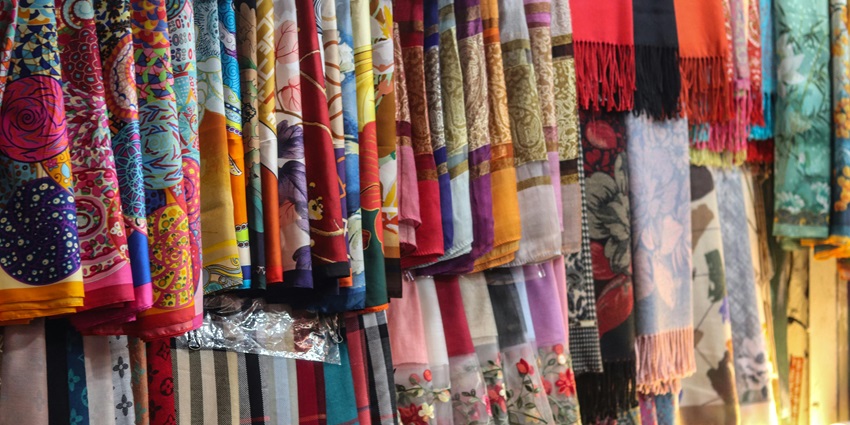View a vibrant assortment of Thai silk scarves with intricate patterns, another highlight among the various things to buy in Pattaya.
