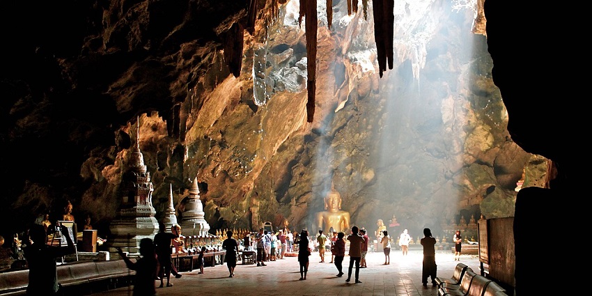 Tham Khao Luang is a famous Cave in Thailand with sunlight streaming through rocks