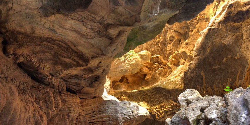 An image showing illuminated rock formations inside one of the caves in Laos
