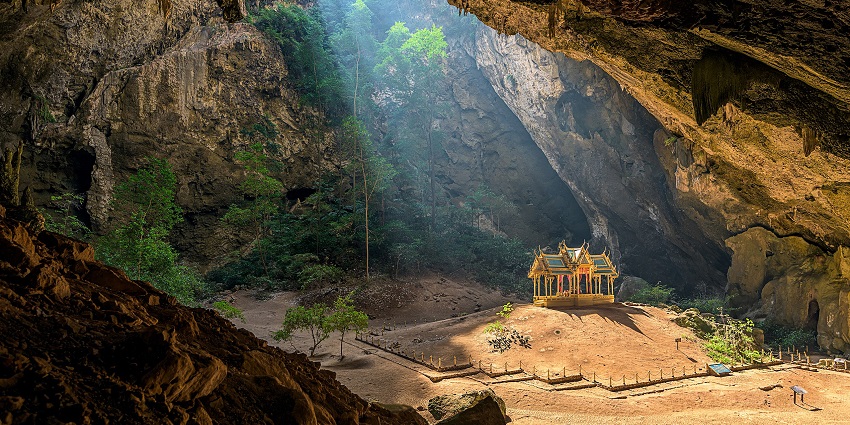 The green landscape at the opening of Tham Pee Hua Toe, one of the caves in Thailand.