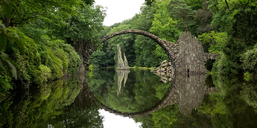 A perfectly arched bridge that forms a circle when reflected in the water, among the famous haunted places in Germany.