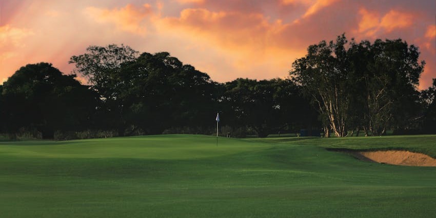 A scenic golf course in Jamaica offering panoramic views, rolling hills, and a mysterious legend tied to its name.