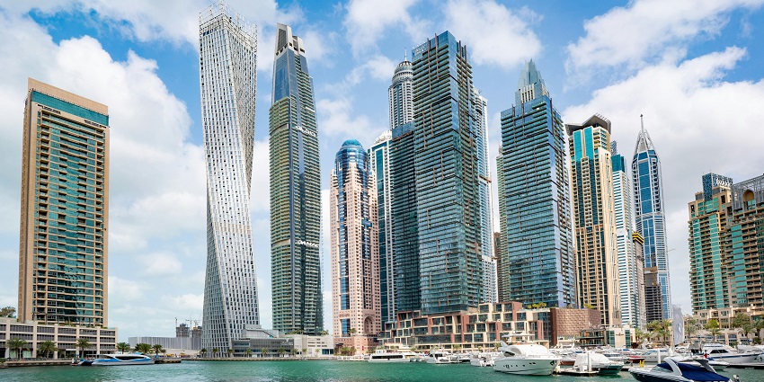 Cityscape of Dubai in August with clear skies, modern buildings, and bustling streets.