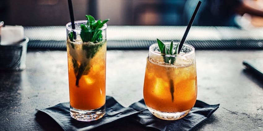 Guests trying classic orange cocktails at Fanelli Cafe, a delicious thing to do in SoHo.