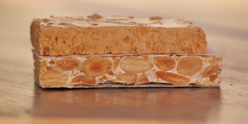 An image showing a view of sliced turrón, one of the most famous things to buy in Spain.