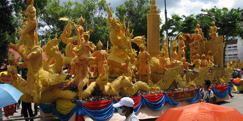 A cultural parade with people marching during the Ubon Ratchathani Candle Festival