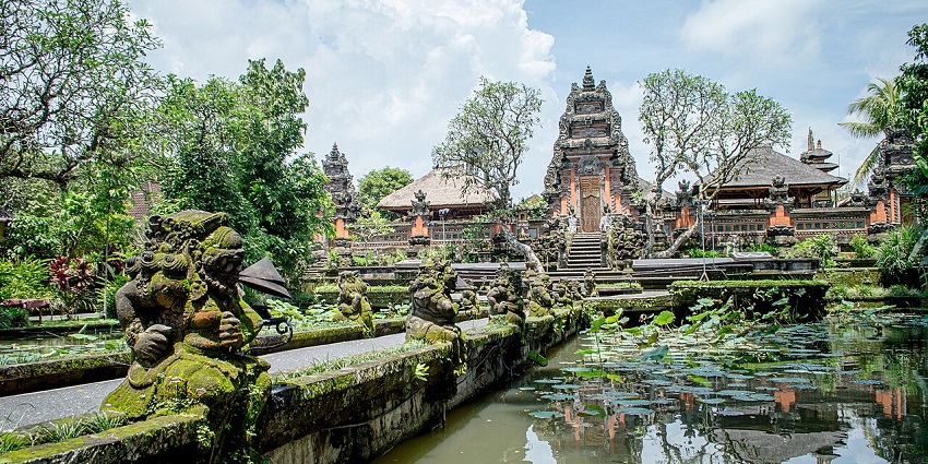 Monkey Forest Street in Ubud, Bali, lined with shops and cafes, bustling with activity.