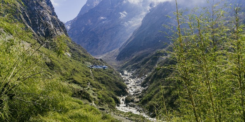 A far view of the hilly terrain, which has terraced farming fields and curved pathways.